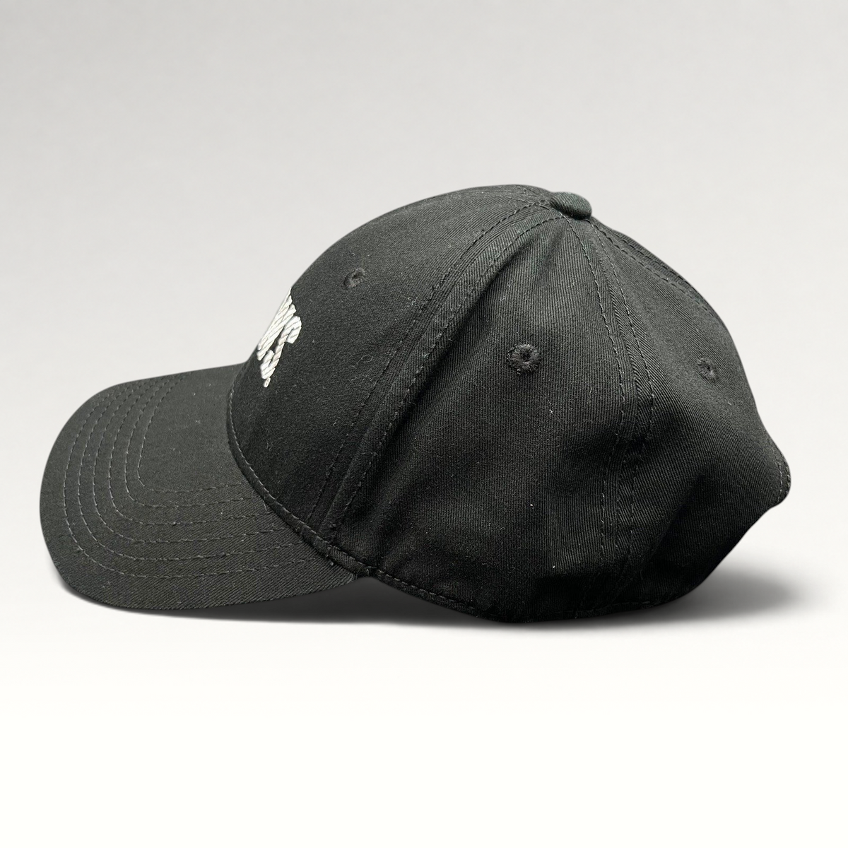 Raree Finds vintage black OTTO Cap snapback hat featuring an embroidered E! News logo, side profile view.