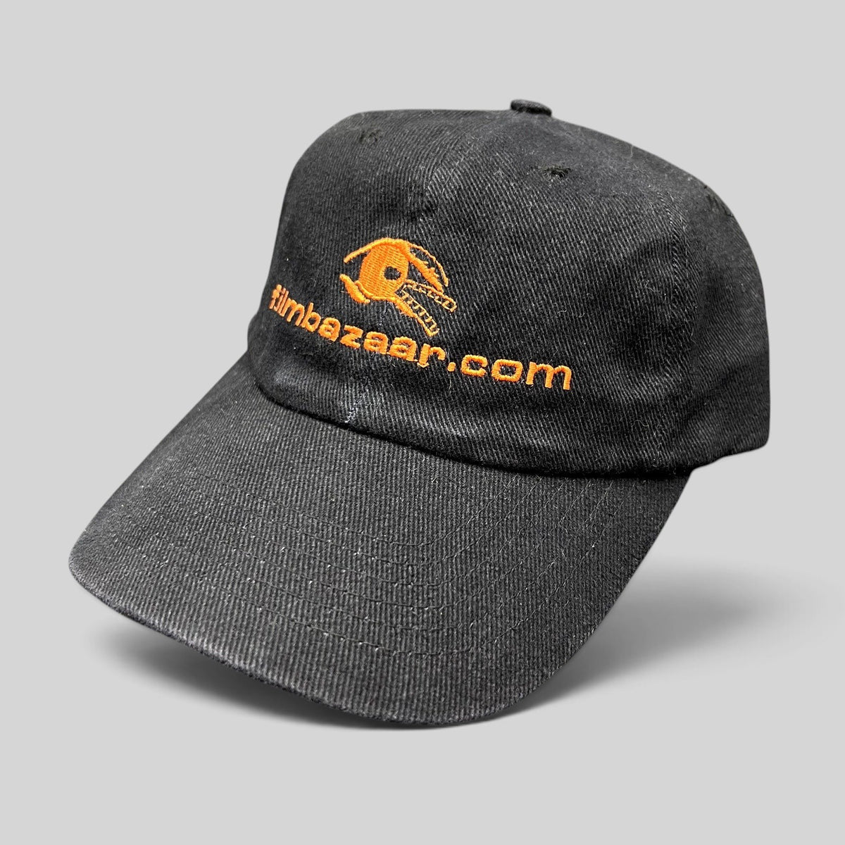 Raree Finds vintage black cotton strapback hat with orange embroidered FilmBazaar.com logo on the front