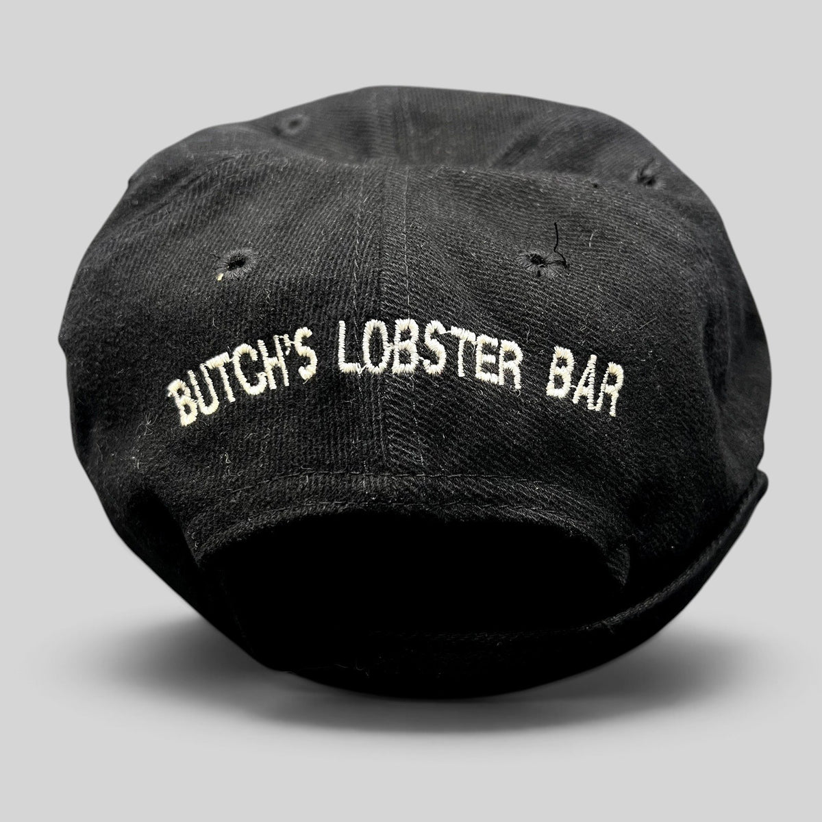Raree Finds vintage 1990s black Timberline strapback hat featuring white embroidered Butch’s Lobster Bar rear branding