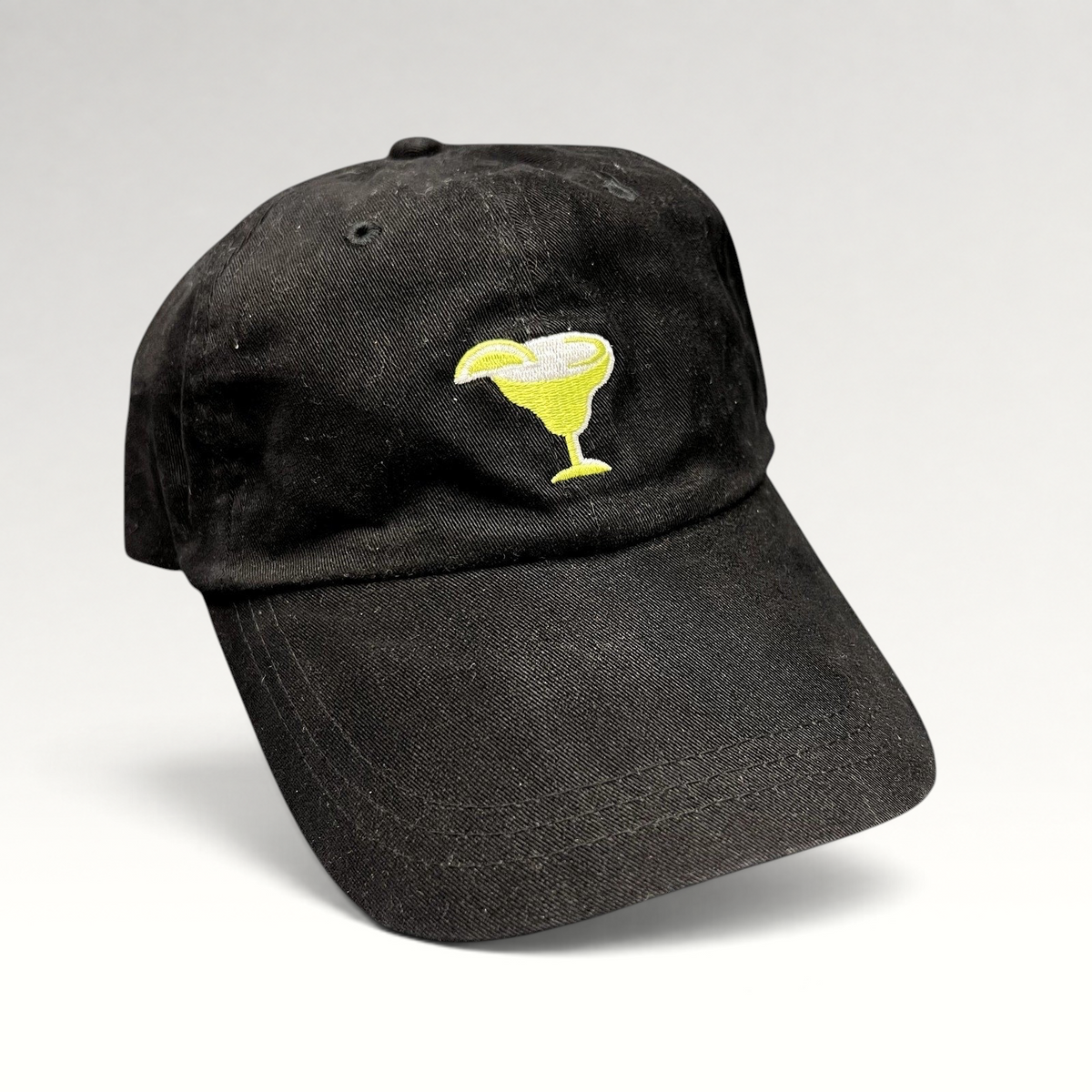 Raree Finds vintage black cotton strapback hat with an embroidered yellow margarita glass logo on the front