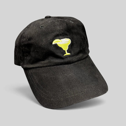 Raree Finds vintage black cotton strapback hat featuring an embroidered margarita glass logo on the front.