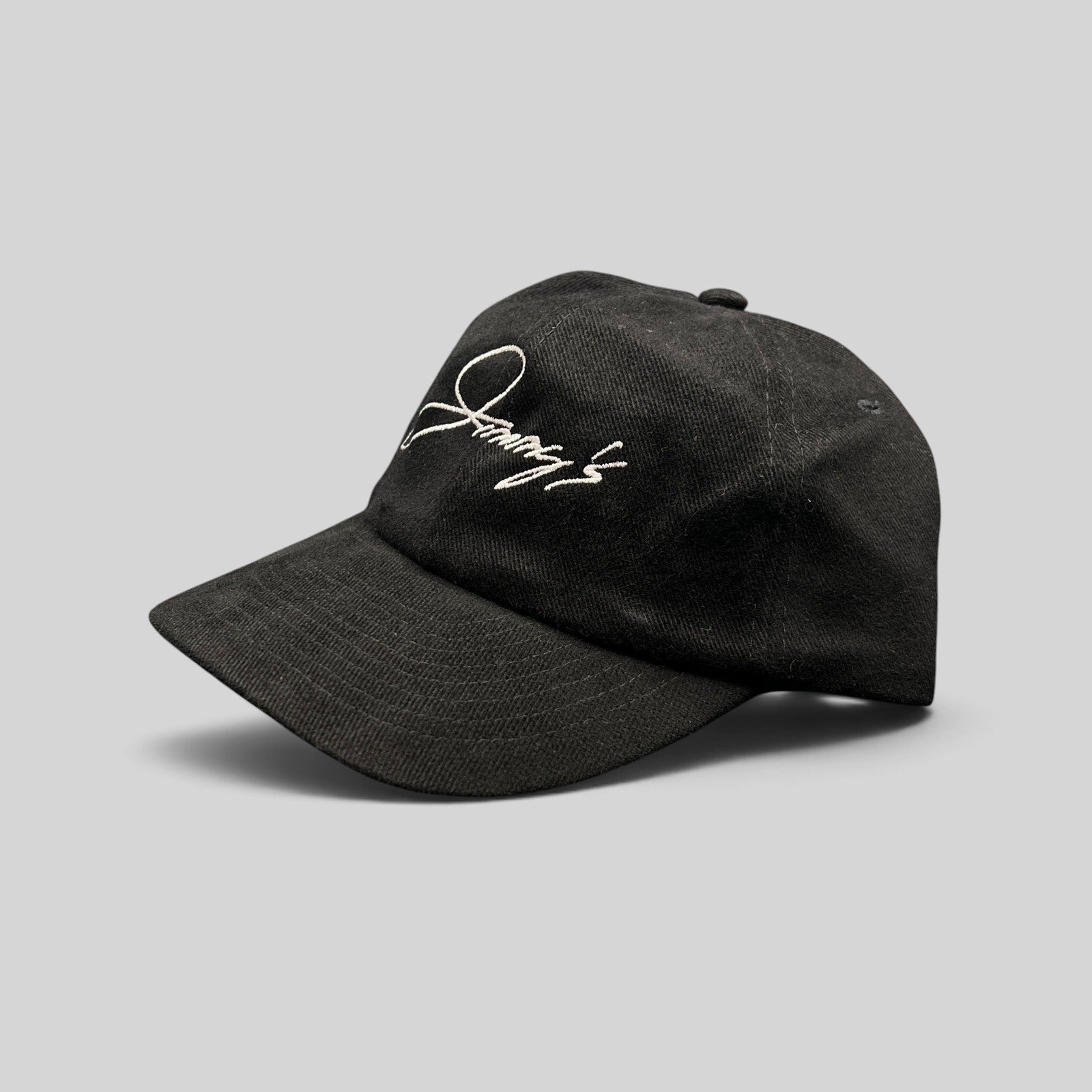 Raree Finds vintage black cotton twill strapback hat with white embroidered Jimmy's script logo and curved brim