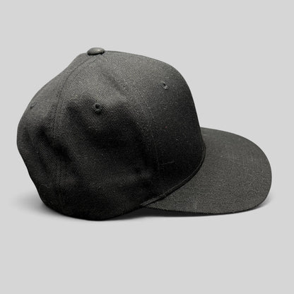 Raree Finds vintage black Yupoong snapback hat with a structured high-profile crown and classic green undervisor.