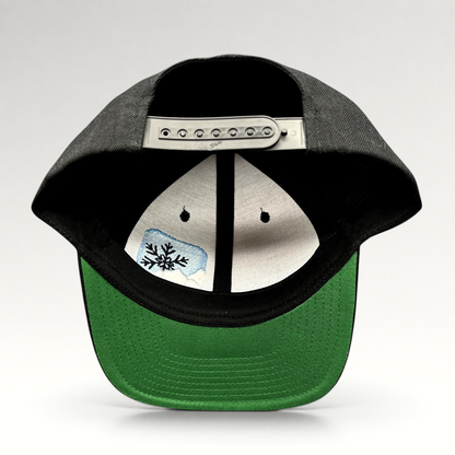 Raree Finds vintage black Yupoong snapback hat with green undervisor and embroidered mountain snowflake logo interior