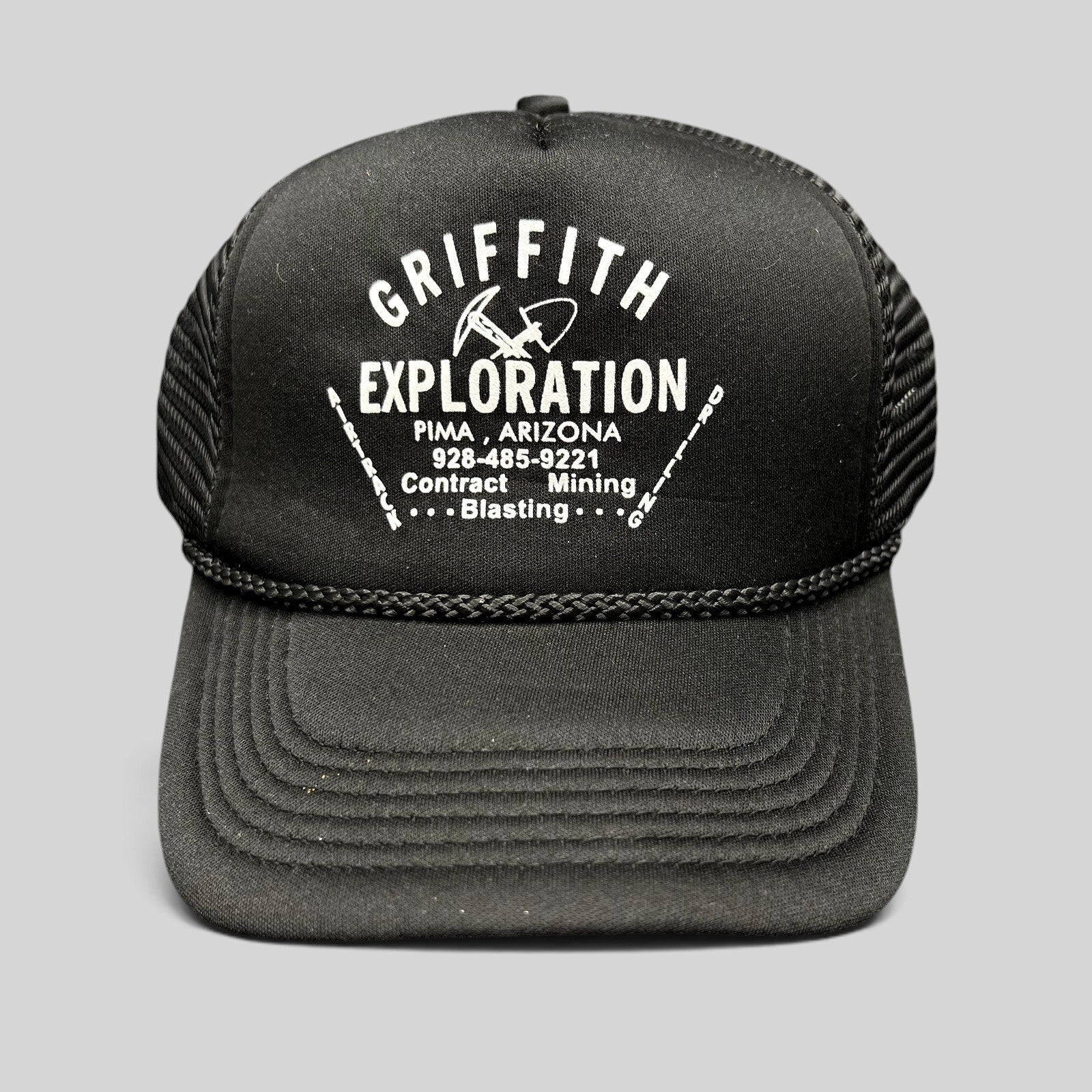 Raree Finds vintage black foam trucker hat with white Griffith Exploration mining company graphic and braided rope