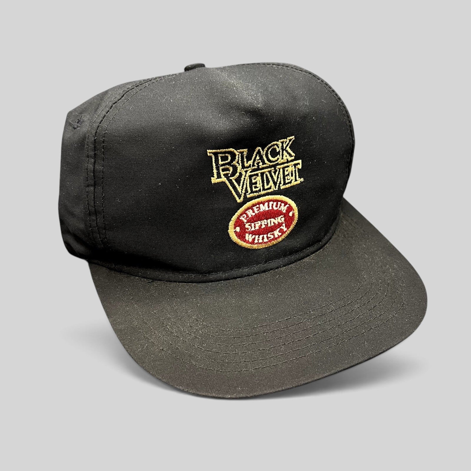 Raree Finds vintage black snapback hat with embroidered Black Velvet Premium Blended Whisky logo and red crest