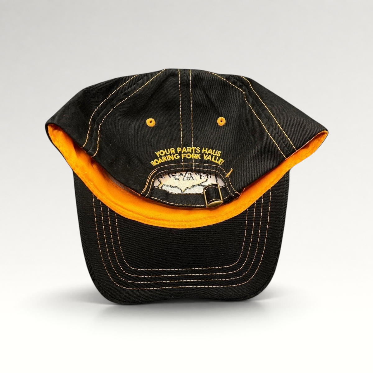 Raree Finds vintage black cotton strapback cap with yellow contrast stitching and embroidered automotive branding