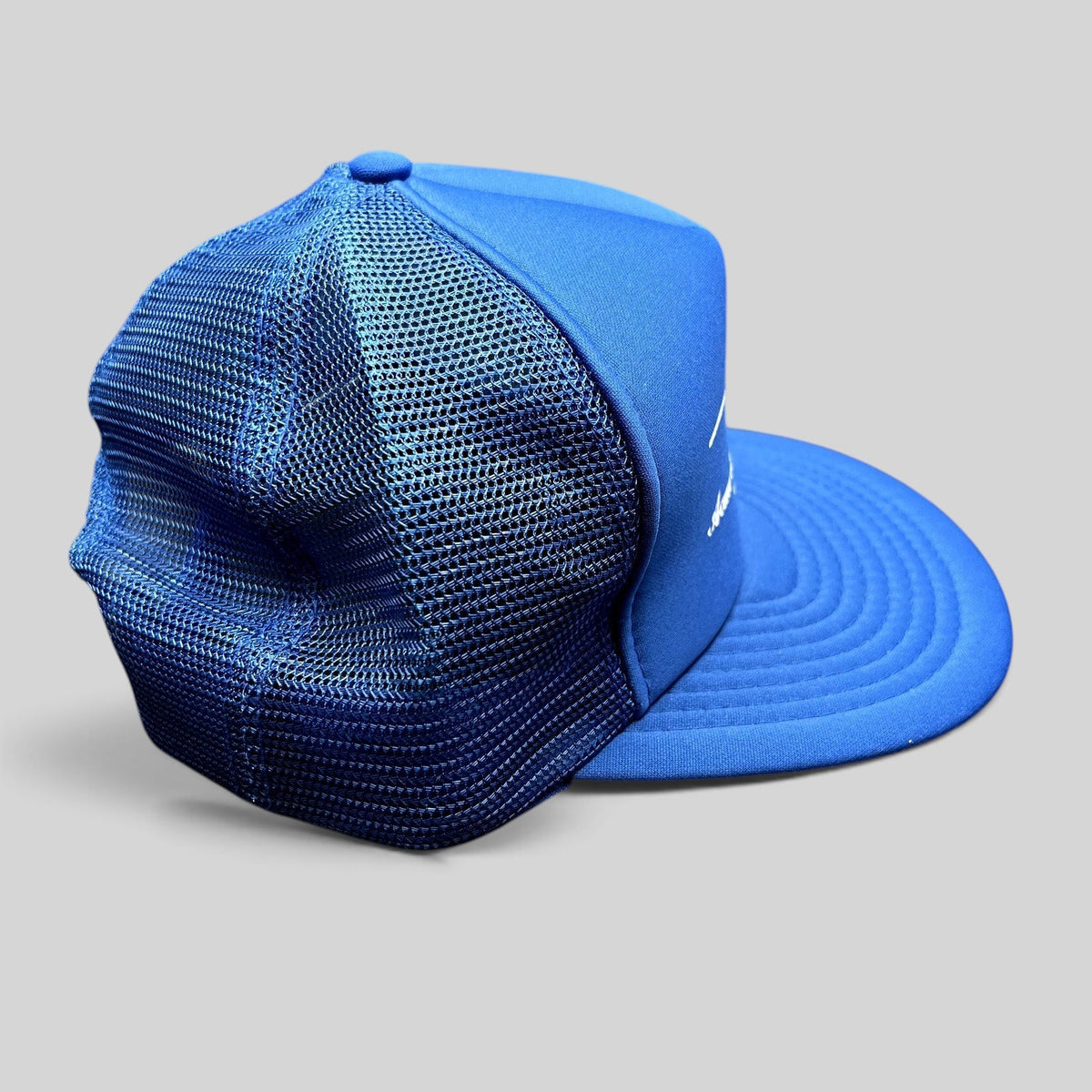 Raree Finds vintage royal blue foam and mesh trucker hat with Acme Electric Supply Co. branding and snapback closure.