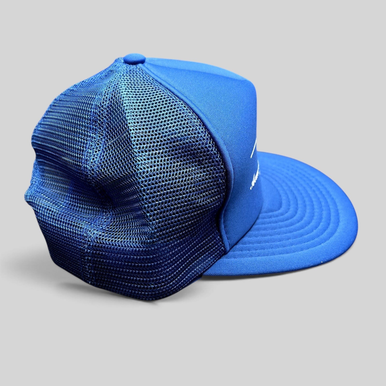 Raree Finds vintage royal blue foam and mesh trucker hat with Acme Electric Supply Co. branding and snapback closure.