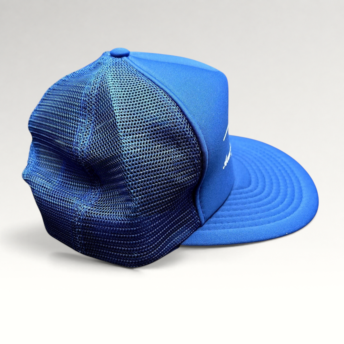 Raree Finds vintage royal blue foam and mesh trucker hat with Acme Electric Supply Co. graphic and snapback closure.
