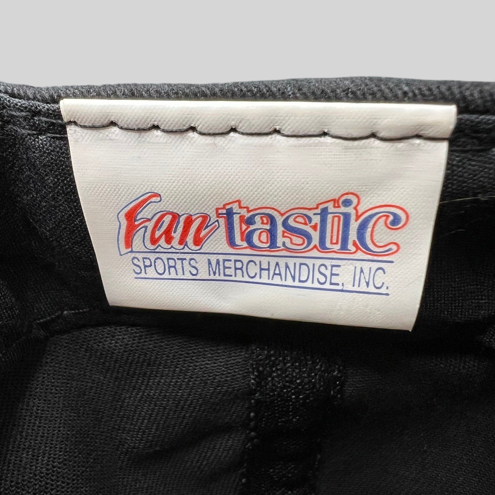 Raree Finds vintage Fantastic Sports Merchandise brand label inside a black DC United snapback hat