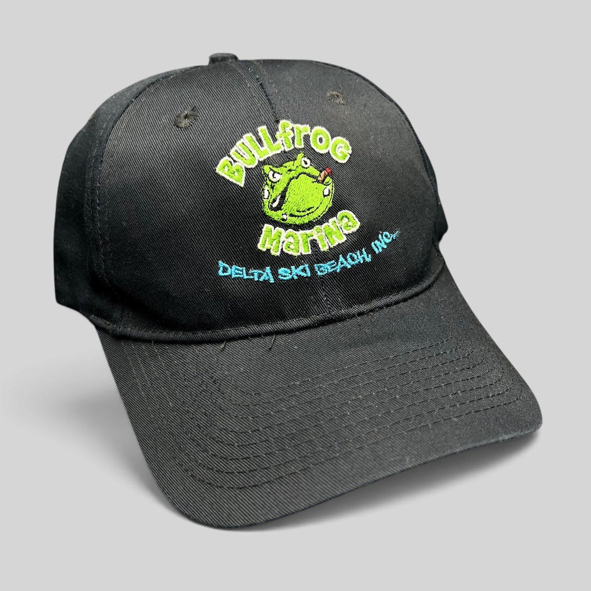 Raree Finds vintage black cotton strapback hat with embroidered Bullfrog Marina frog logo and aqua blue text