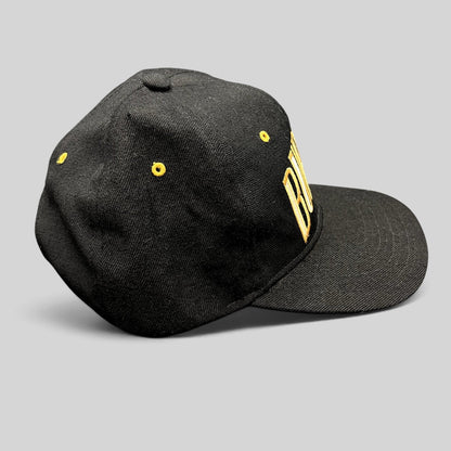Raree Finds vintage black Burton Snowboards snapback hat with gold embroidered lettering and yellow eyelets