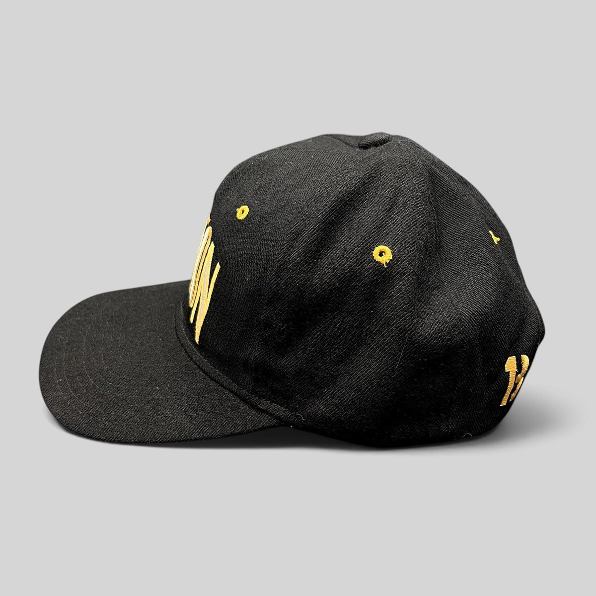 Raree Finds vintage black Burton Snowboards snapback hat with gold embroidery and green undervisor