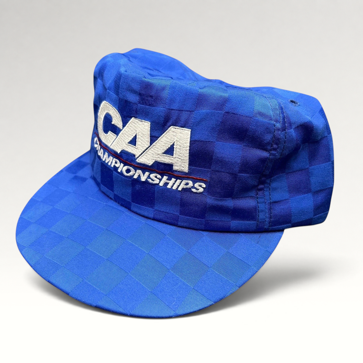 Raree Finds vintage royal blue checkered CAA Championships snapback hat with white embroidered lettering and flat bill.