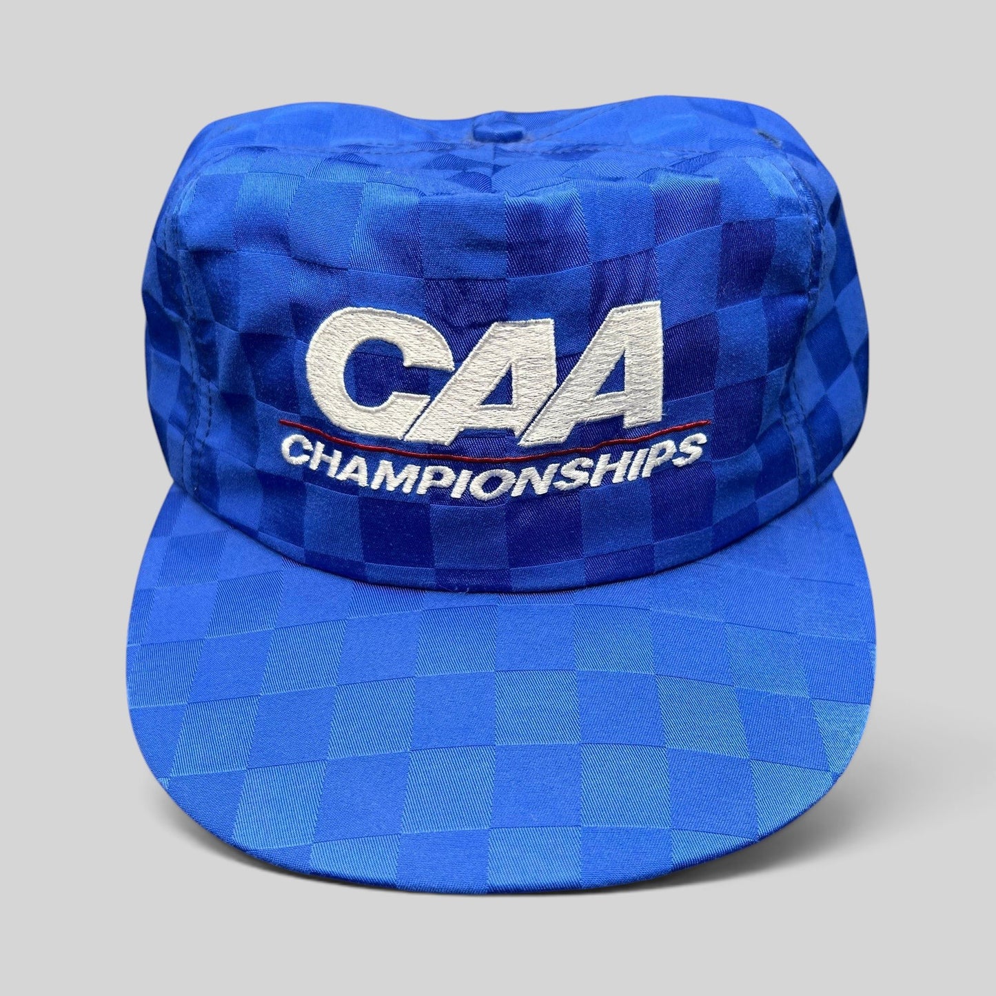 Raree Finds vintage royal blue checkered CAA Championships snapback hat with white embroidered lettering and flat bill.