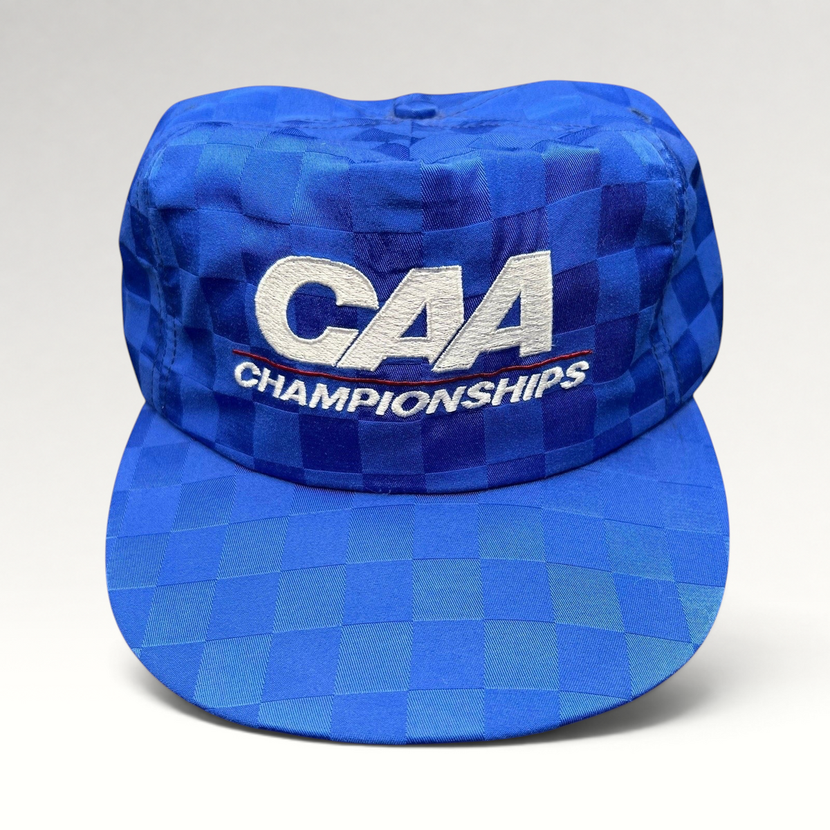 Raree Finds vintage royal blue checkered CAA Championships snapback hat with white embroidered lettering and flat bill.