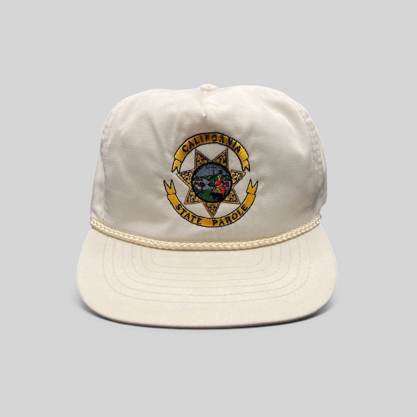 Raree Finds vintage 90s white Otto snapback hat featuring an embroidered California State Parole emblem and rope trim.