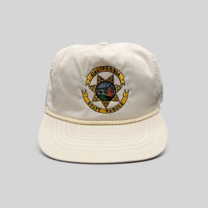 Raree Finds vintage 90s white Otto snapback hat featuring an embroidered California State Parole emblem and rope trim.