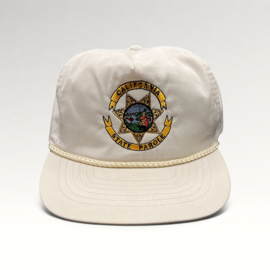 Raree Finds vintage 90s white Otto snapback hat featuring an embroidered California State Parole emblem and rope trim.