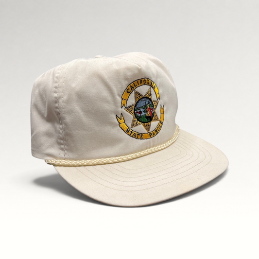Raree Finds vintage 90s white Otto snapback hat featuring an embroidered California State Parole emblem and rope trim.