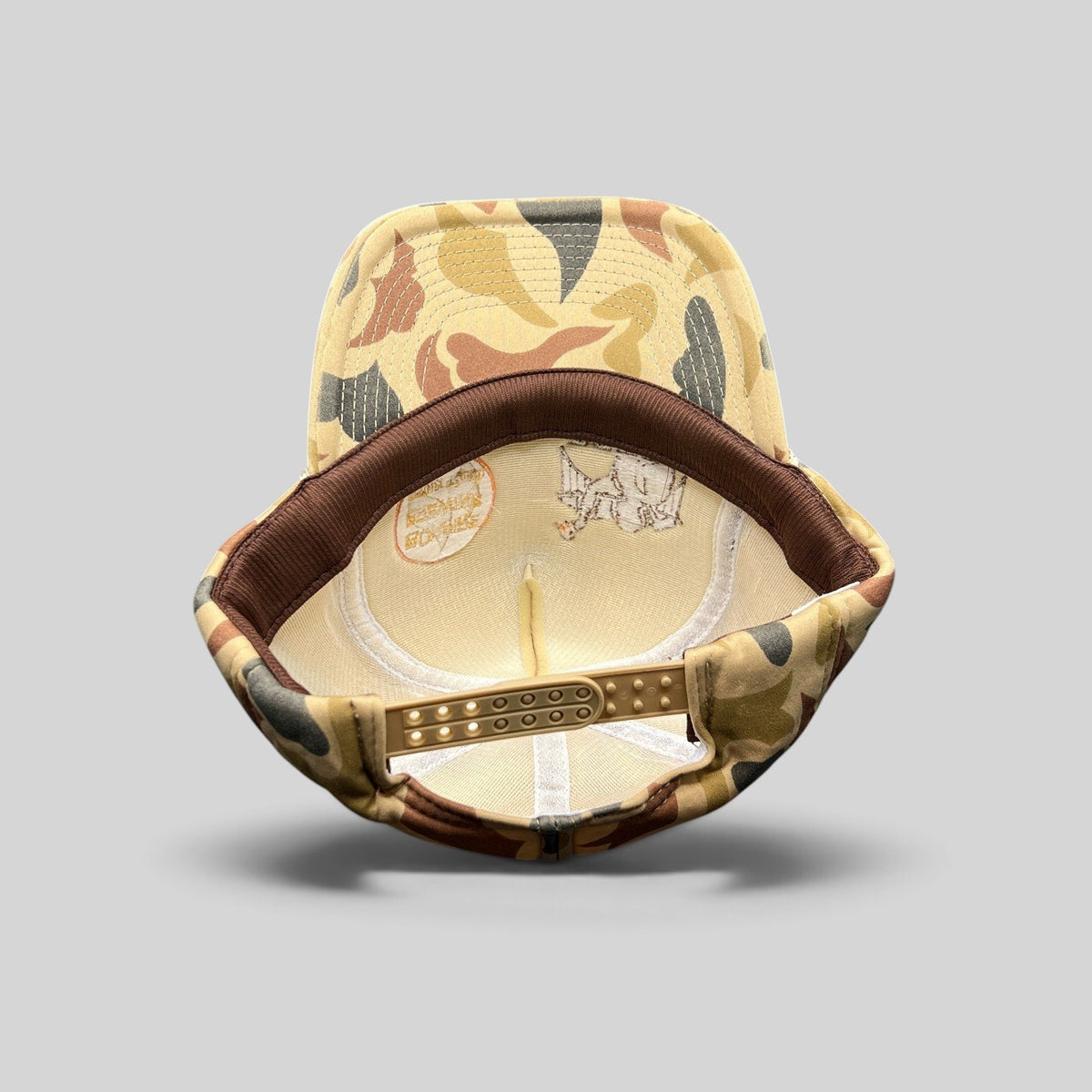 Raree Finds vintage Bonfire Brewing Co camo snapback hat showing the interior plastic snap closure and COBRA tag