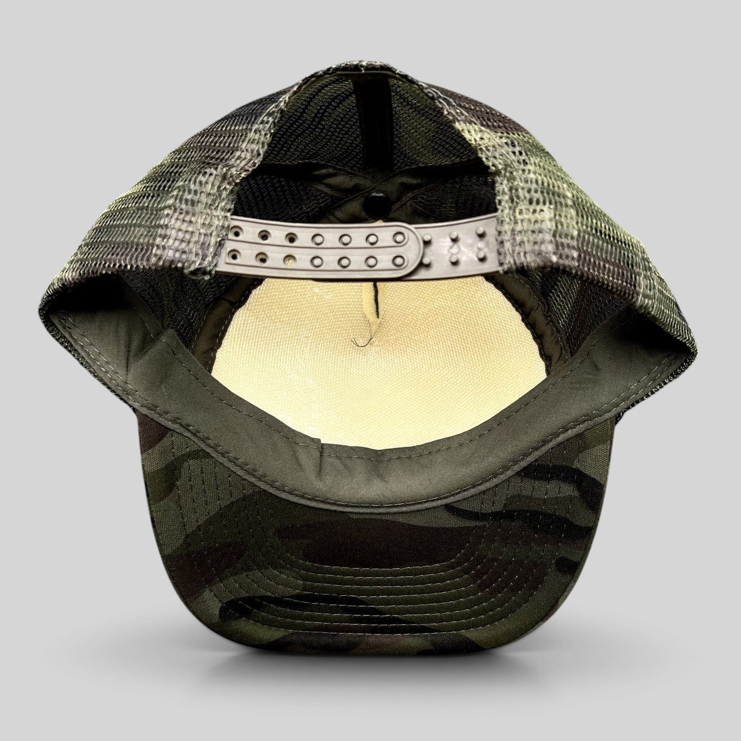 Raree Finds vintage Cloud 9 Aspen trucker hat showing the interior mesh back, camo brim, and adjustable snapback strap.