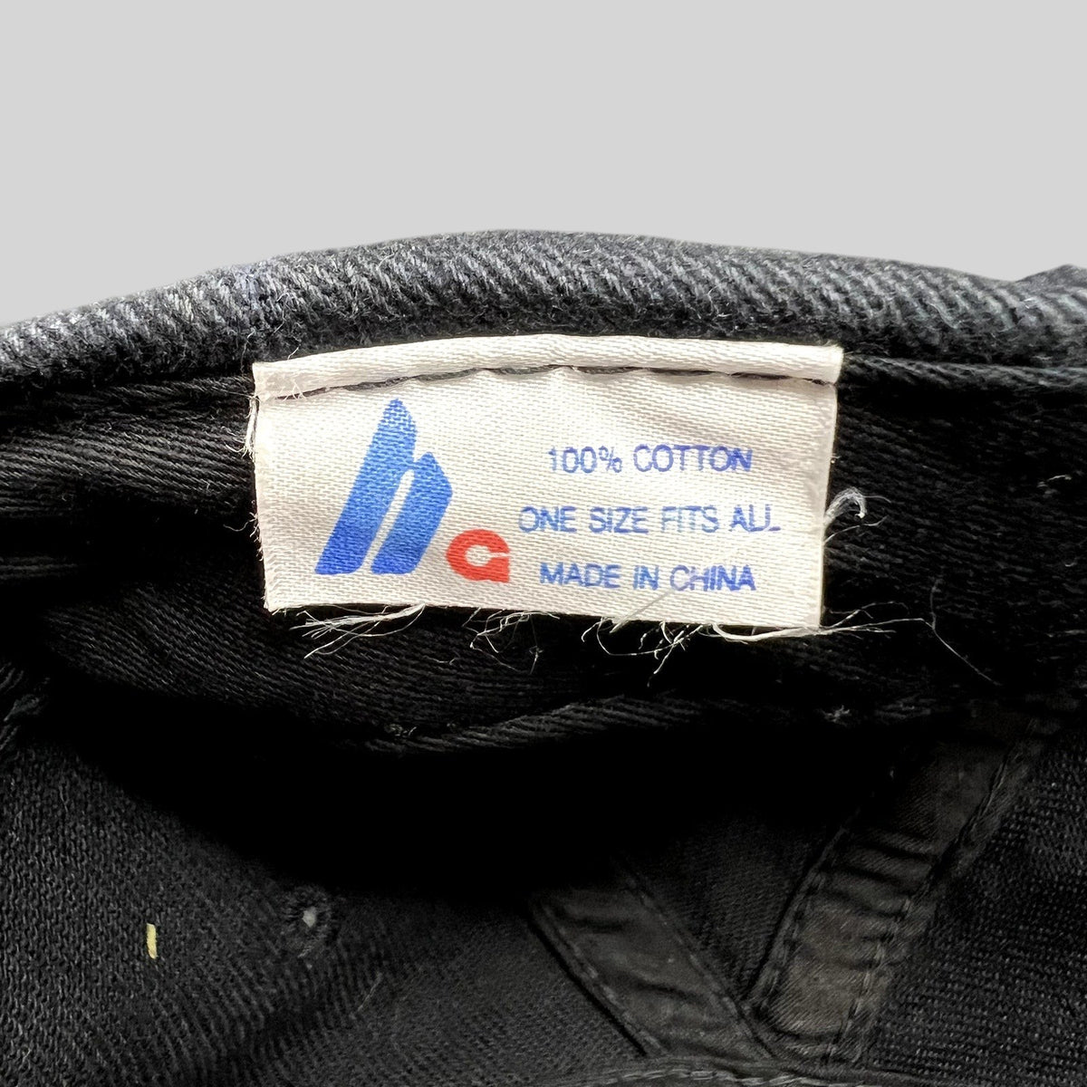 Raree Finds vintage FilmBazaar cap interior label showing 100 percent cotton, one size fits all, and made in China