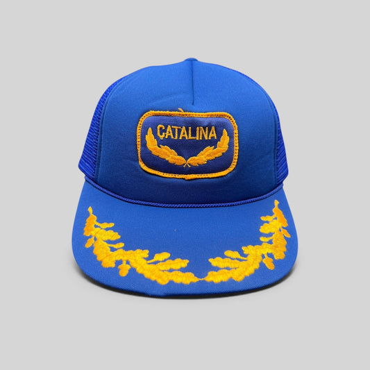 Raree Finds vintage 1980s royal blue foam trucker hat with gold Catalina patch and embroidered laurel brim detail