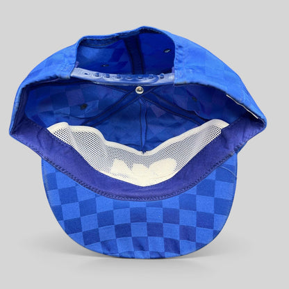 Raree Finds vintage royal blue checkered snapback hat showing the interior mesh lining and adjustable plastic strap.