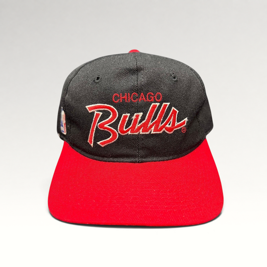 Raree Finds vintage 90s Chicago Bulls snapback hat with red and white script embroidery on a black crown and red brim