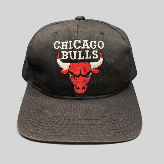 Raree Finds vintage 90s Chicago Bulls AJD snapback hat in black with red embroidered team logo and green undervisor.