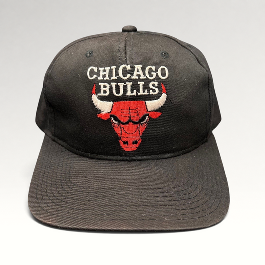 Raree Finds vintage 90s Chicago Bulls AJD snapback hat in black with red embroidered team logo and green undervisor.