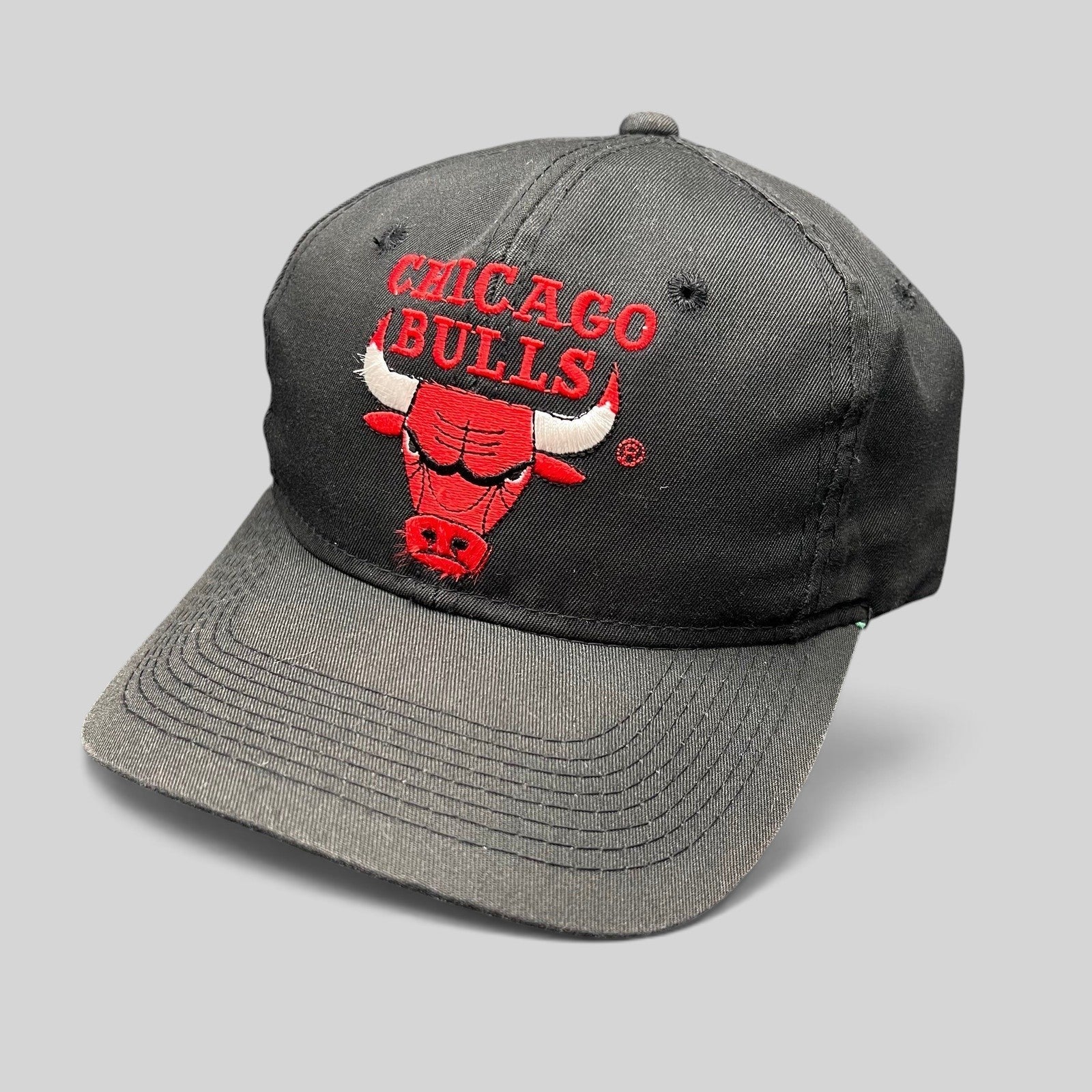 Raree Finds vintage 90s Chicago Bulls snapback hat in black with red embroidered team logo and green under-visor