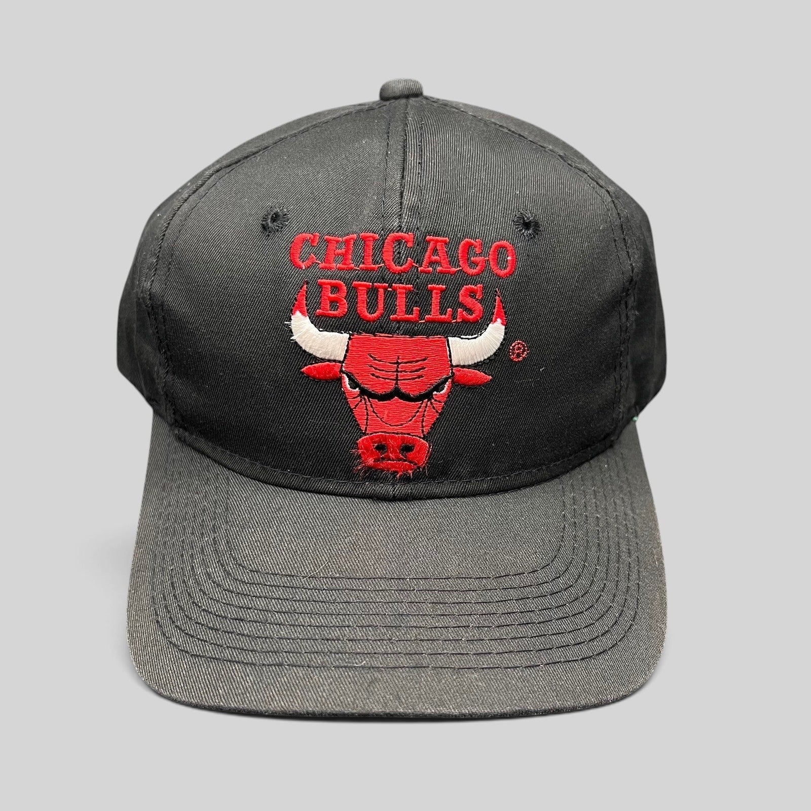 Raree Finds vintage 90s Chicago Bulls snapback hat in black with red embroidered team logo and green under-visor