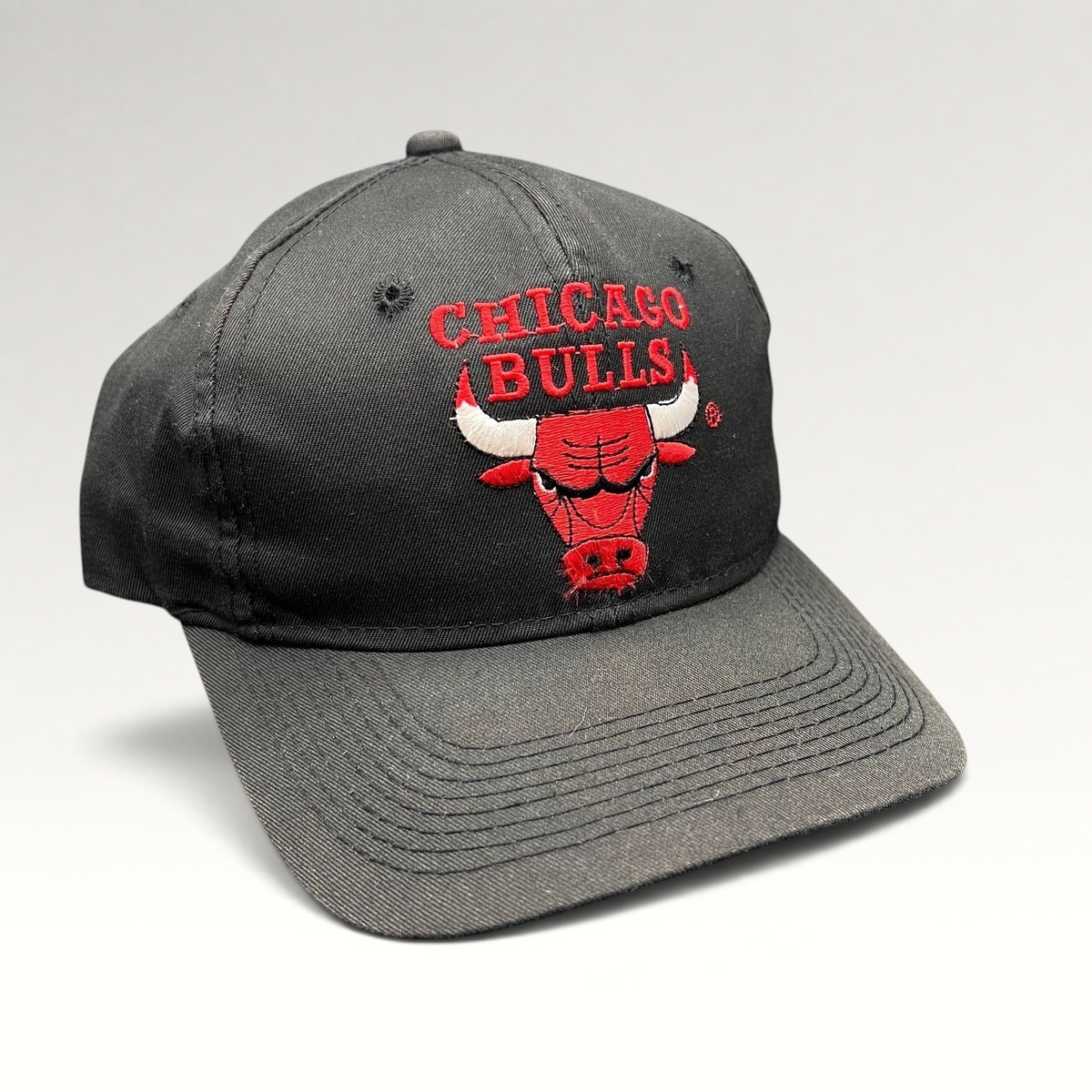Raree Finds vintage 90s Chicago Bulls snapback hat in black with red embroidered team logo and green under-visor