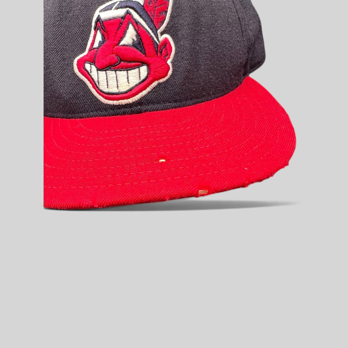 Raree Finds vintage New Era 59FIFTY Cleveland Indians wool cap with embroidered Chief Wahoo logo and red brim