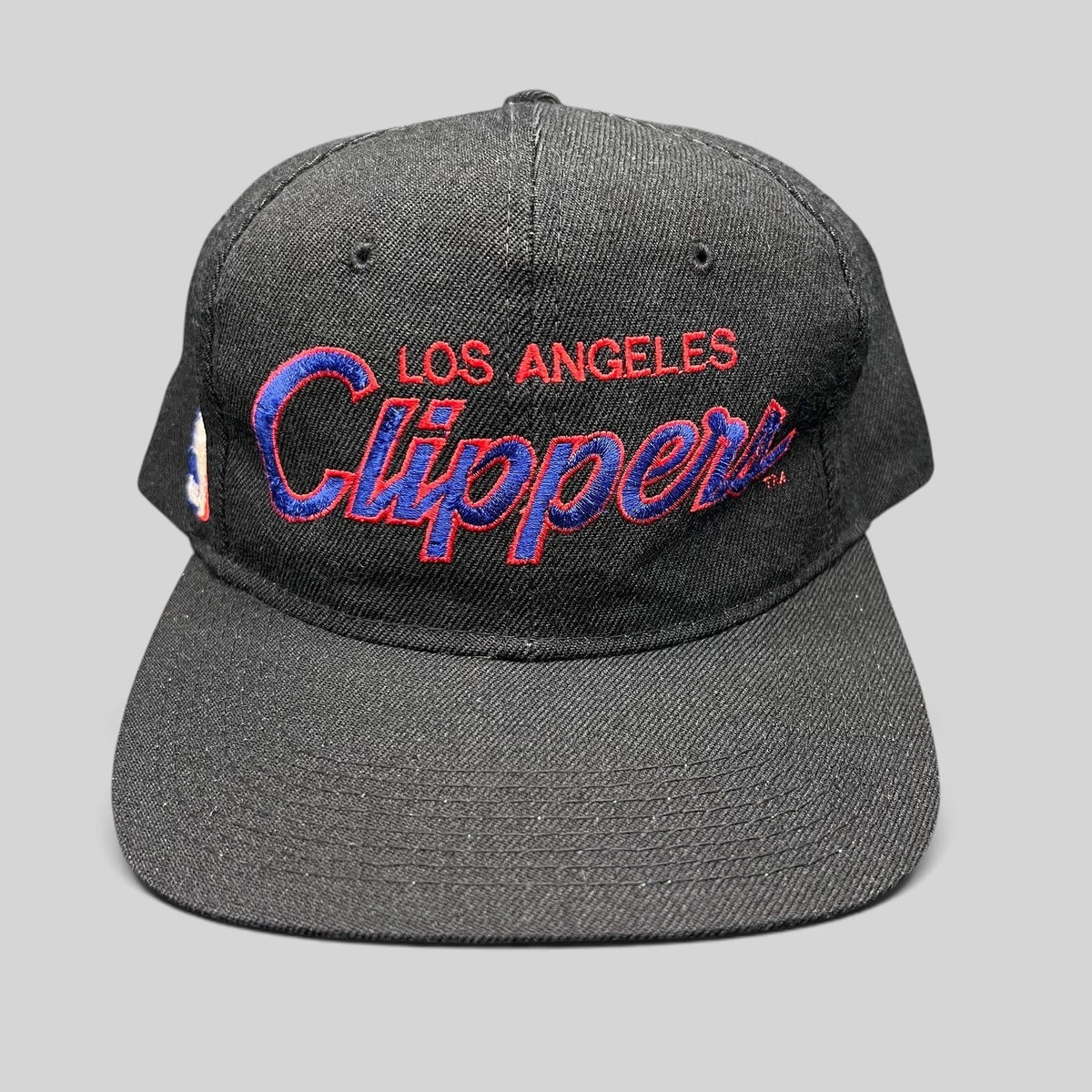 Raree Finds vintage Sports Specialties Los Angeles Clippers black snapback hat with red and blue script embroidery