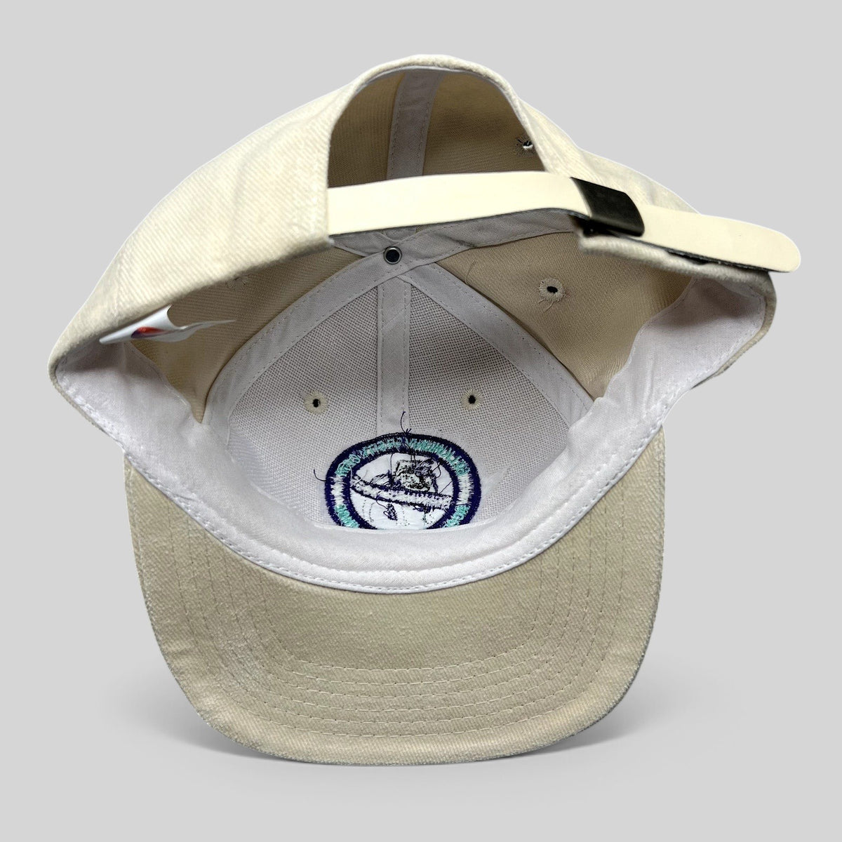 Raree Finds vintage cream cotton strapback hat by Headmost showing the interior construction and metal clasp