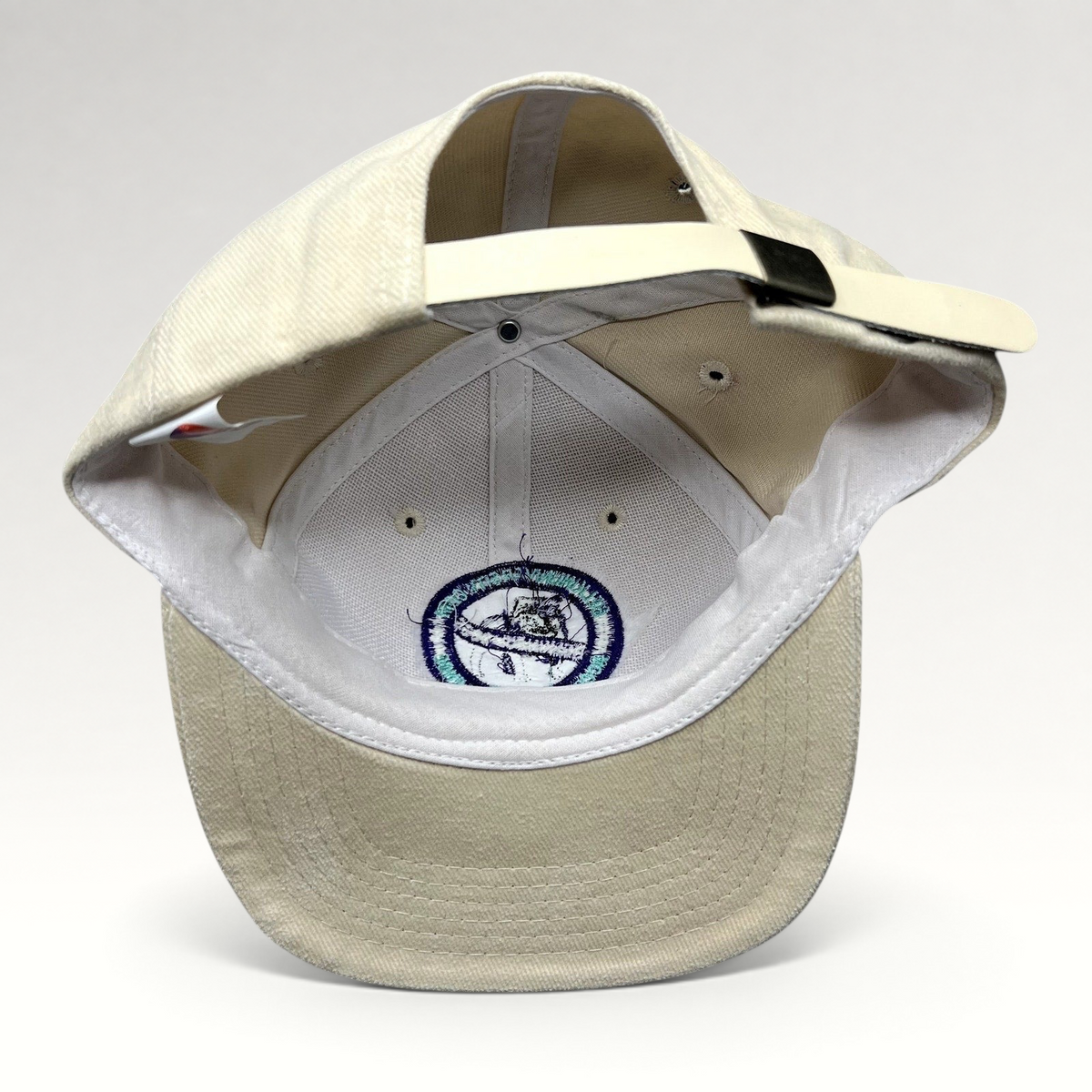 Raree Finds vintage cream cotton strapback hat by Headmost showing the interior construction and metal clasp