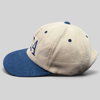 Raree Finds vintage DEA strapback hat in tan cotton with a navy blue brim and embroidered lettering