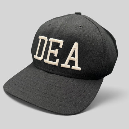 Raree Finds vintage New Era DEA strapback hat in black with bold white embroidered lettering on the crown