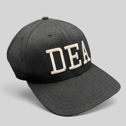 Raree Finds vintage black New Era DEA strapback hat with white embroidered lettering, made in USA.