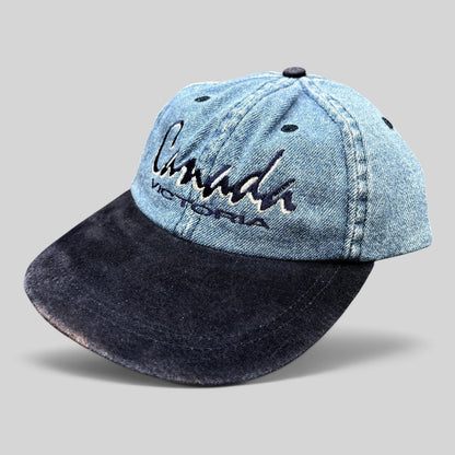 Raree Finds vintage 90s Canada Victoria snapback hat with light wash denim crown and dark navy suede-style brim.