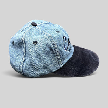 Raree Finds vintage 90s Canada Victoria snapback hat with light wash denim crown and dark navy suede-style brim.