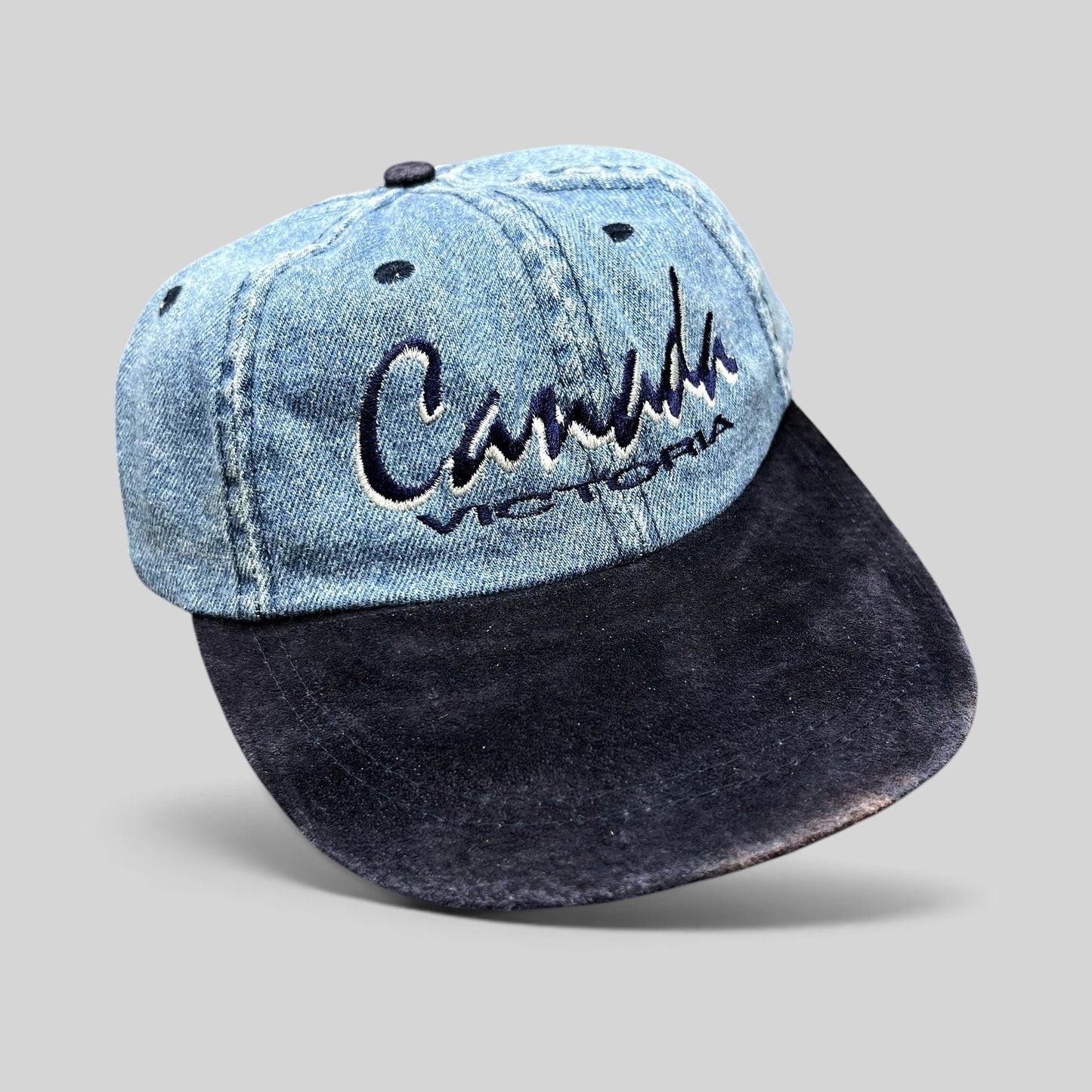 Raree Finds vintage 90s Canada Victoria snapback hat with a light wash denim crown and navy suede-style brim.