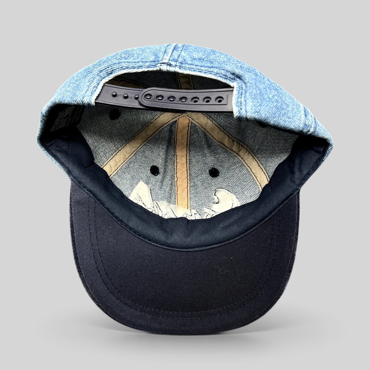 Raree Finds vintage 90s Canada Victoria snapback hat showing the interior light wash denim crown and navy suede brim