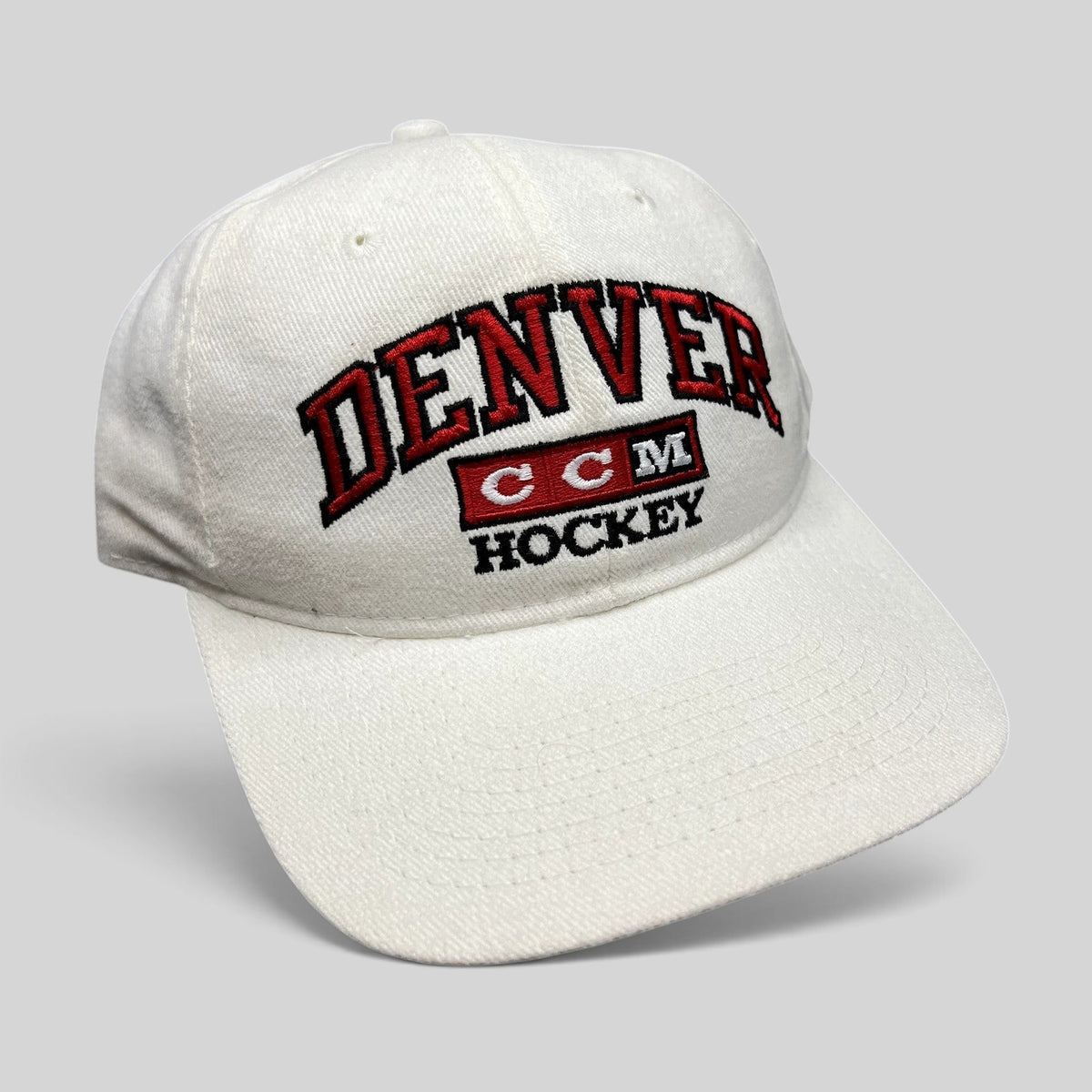 Raree Finds vintage white Denver Hockey snapback hat with red and black embroidered CCM logo, made in Canada.