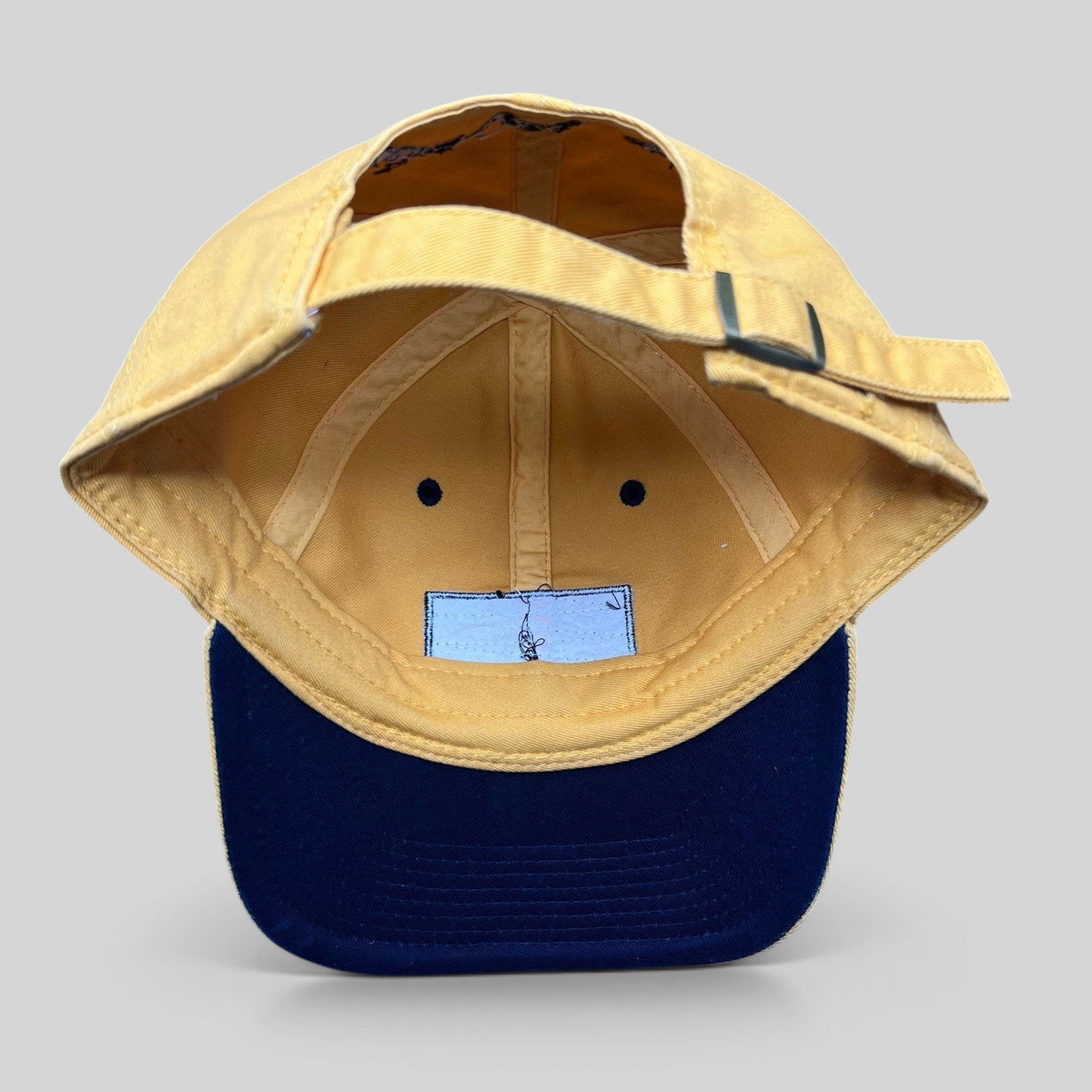 Raree Finds vintage Walt Disney World yellow cotton strapback hat with metal buckle closure, interior view