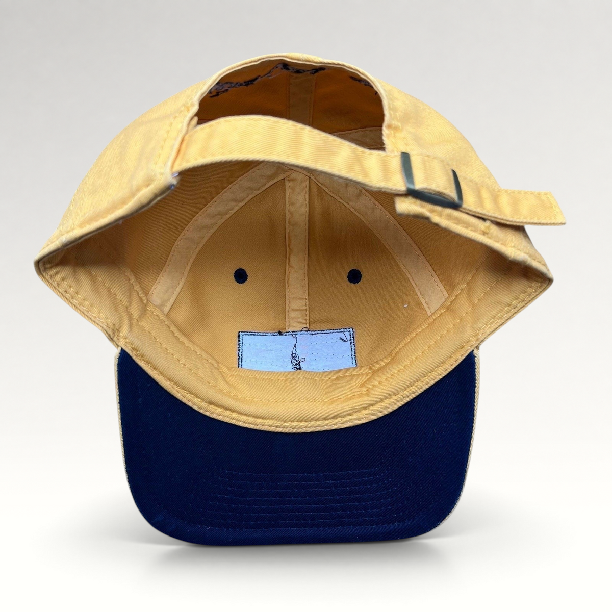 Raree Finds vintage Walt Disney World yellow cotton strapback hat with metal buckle closure, interior view